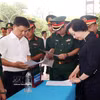 政府副总理范氏清茶检查烈士遗骸搜寻归葬行动启动仪式准备工作。图自越通社