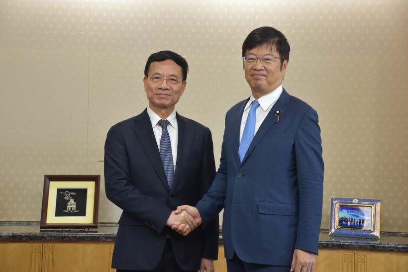 越共中央委员、科技部部长阮孟雄（左）和日本总务省国务大臣足立正司。图自越通社