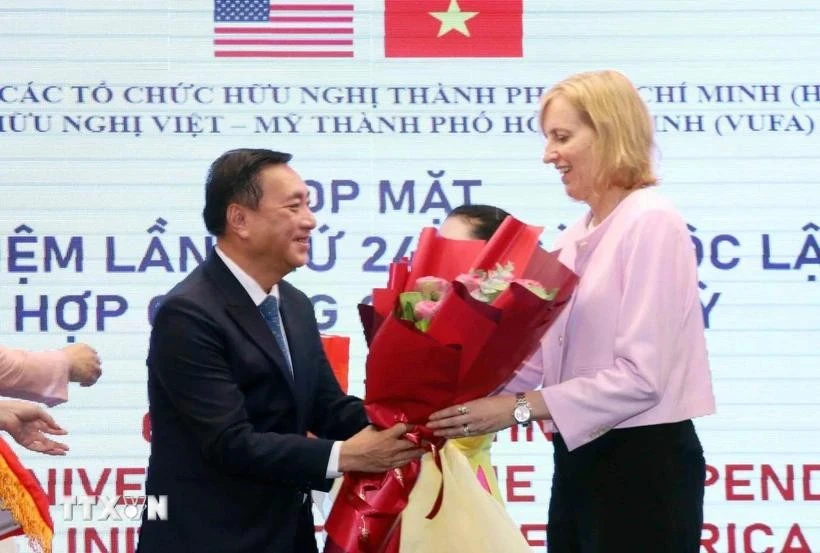 范成坚先生向美国驻胡志明市总领事苏珊·伯恩斯献花祝贺。图自越通社