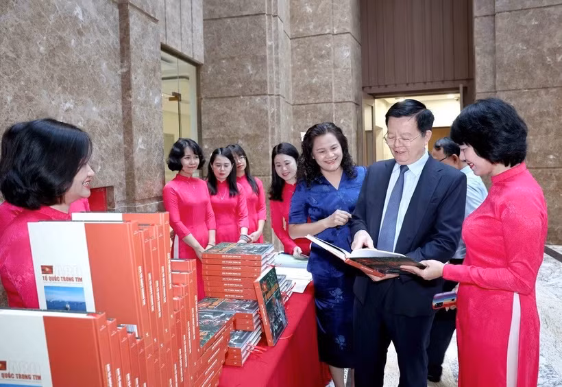 越南政府副总理梅文政参观越英双语画册《A80：祖国在心中》展览。图自越通社