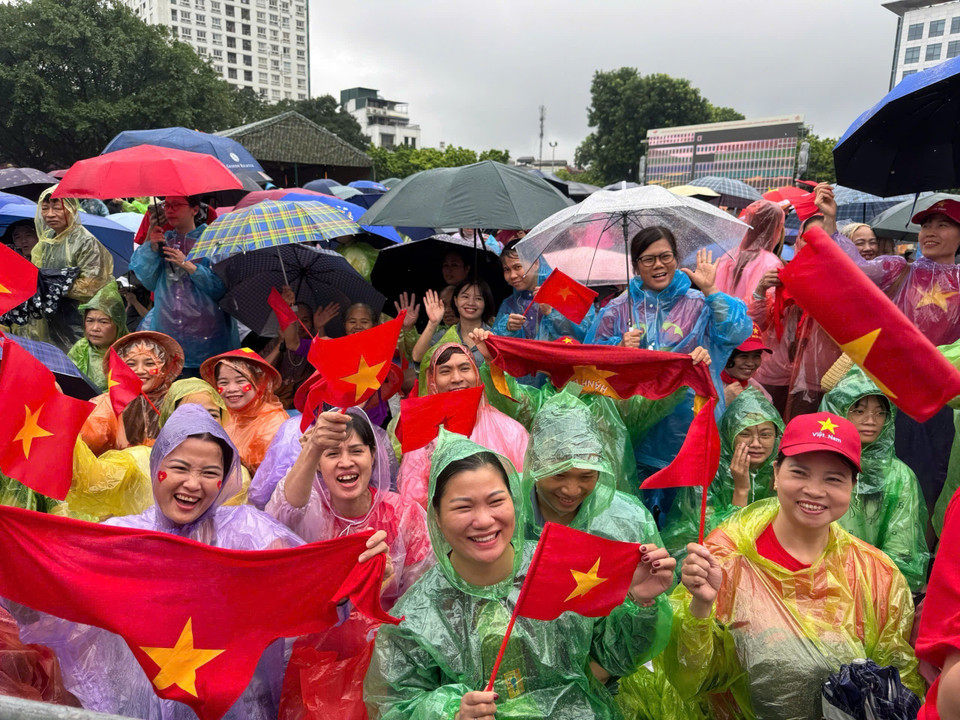 在大雨中，首都河内的市民无惧恶劣天气，耐心守候，只为即将登场的武装力量方阵加油助威。图自越通社。
