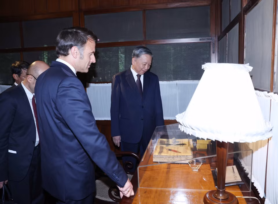 苏林总书记与法国总统埃马纽埃尔·马克龙参观设在胡志明主席遗迹区内的胡伯伯高脚屋。图自 越通社