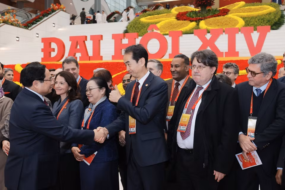 越南政府总理范明政在越南共产党第十四次全国代表大会闭幕会议期间同出席会议的国际代表互动交流。图自 越通社