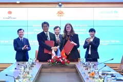 签字仪式现场。图自越通社