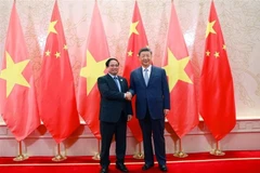 越南政府总理范明政会见中共中央总书记、国家主席习近平。图自越通社