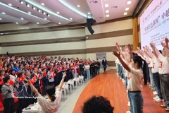 越中两国青年与各位嘉宾一同高歌友谊歌曲《越南-中国》之歌。图自越通社