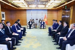 范明政在会见中国商用飞机有限责任公司(COMAC)副总经理沈波。图自越通社