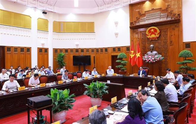 会议场景。图自越通社 vna-potal-thu-tuong-hop-trien-khai-ke-hoach-khi-thuc-hien-mo-hinh-to-chuc-chinh-quyen-dia-phuong-02-cap-8038178.jpg