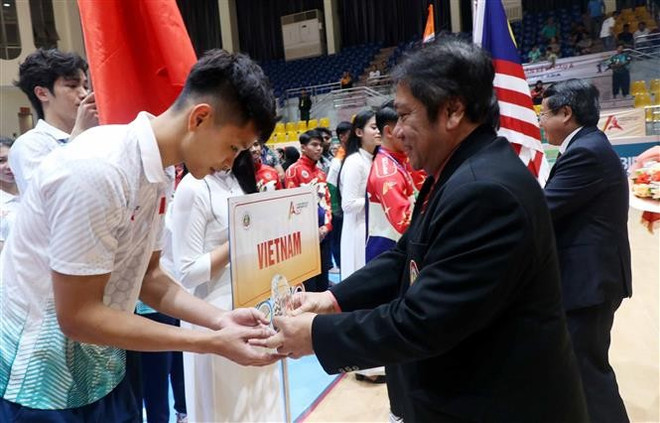 世界班卡西拉联合会秘书长泰迪·苏拉特马吉向越南代表团赠送鲜花和纪念旗。图自越通社 vna-potal-khai-mac-giai-vo-dich-pencak-silat-chau-a-lan-thu-9-8172304.jpg