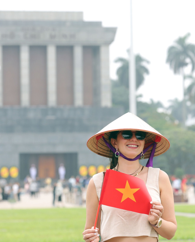 外国游客兴致勃勃地与越南国旗合影留念。图自越通社 anh-8.jpg