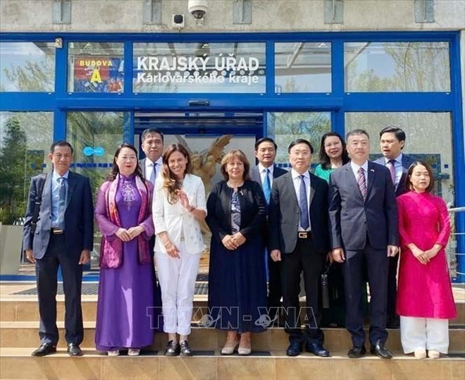 工作代表团成员与越南驻捷克大使杨怀南、卡洛维发利市市长安德烈娅·费费尔·费尔克洛娃(Andrea Pfeffer Ferklová)以及卡洛维发利州议会成员合影留念。 vna-potal-tang-cuong-hop-tac-giua-cac-tinh-thanh-cua-viet-nam-voi-ch-sec-stand-1.jpg