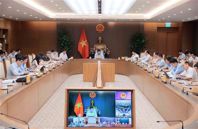 会议场景。图自越通社 vna-potal-pho-thu-tuong-nguyen-chi-dung-chu-tri-phien-hop-thu-nhat-cua-to-cong-tac-lien-nganh-dieu-phoi-xay-dung-8152857.jpg