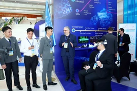代表在《河内公约》开签仪式上参观联合国技术展示区。图自越通社