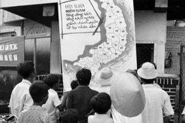 刚刚解放的平顺省潘切市人民在信息室观看战争地图上的胜利消息（1975年4月）。图自越通社