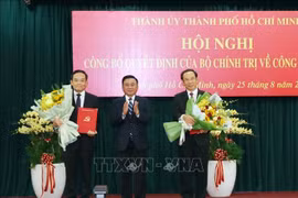 中央书记处常务书记陈锦秀向阮文年同志和陈流光同志颁授越共中央政治局的任命决定。图自越通社