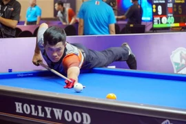 杨成伦球手参加比赛。图自越通社