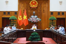 黎明兴总理主持会议。图自越通社