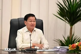 老挝人民革命党中央总书记、国家主席通伦·西苏里在纪念活动上致辞。图自越通社