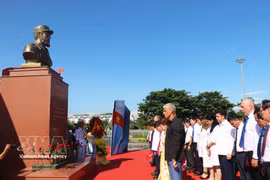 代表们在活动上向菲德尔·卡斯特罗敬献鲜花，默哀一分钟。图自越通社