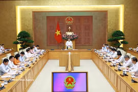 越南政府总理黎明兴与财政部领导举行工作会议。图自越通社