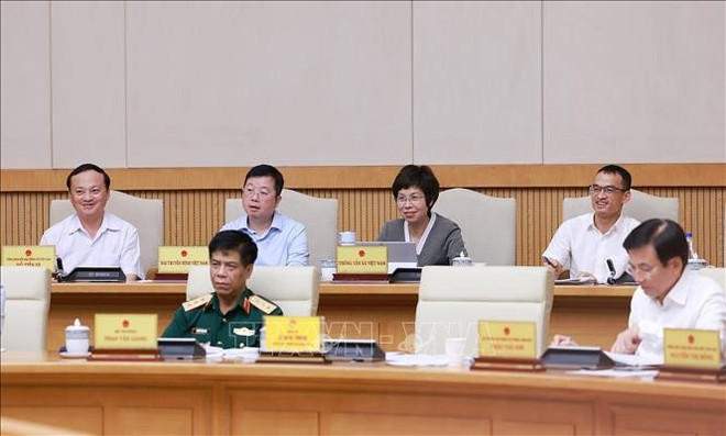 与会代表。图自越通社 vna-potal-thu-tuong-chu-tri-hop-danh-gia-ket-qua-van-hanh-mo-hinh-chinh-quyen-dia-phuong-hai-cap-stand-1.jpg