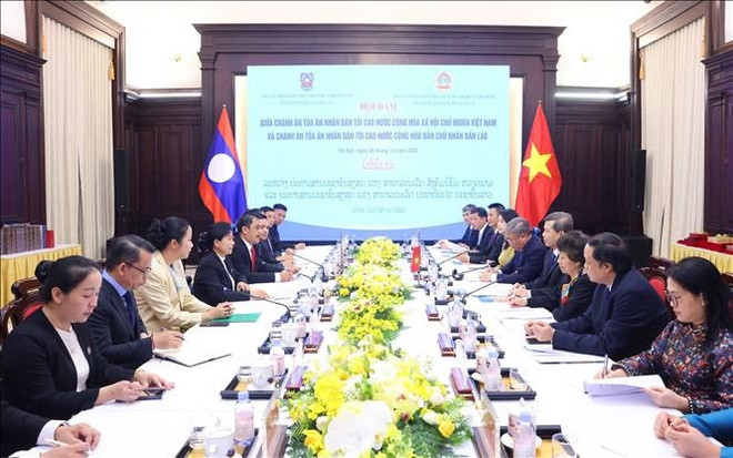 vna-potal-chanh-an-toa-an-nhan-dan-toi-cao-le-minh-tri-hoi-dam-voi-chanh-an-toa-an-nhan-dan-toi-cao-lao-stand.jpg