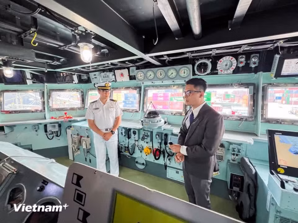 日本军官在驾驶室内向参观者介绍操控设备。图自 Vietnam+
