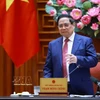 越南政府总理范明政与能源安全保障工作组举行能源安全工作会议。图自越通社