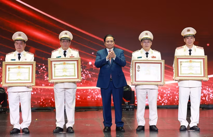 范明政总理向在工作中取得优异成绩的集体和个人授予“人民武装力量英雄”称号和一级军功勋章。图自越通社