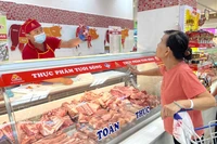 在胡志明市李常杰Co.opmart超市的Vissan柜台，市民正在购买猪肉。图自越通社