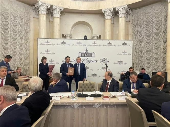 越南科技翰林院（VAST）院长周文明教授荣幸地从俄罗斯科学院院长、俄罗斯劳动英雄根纳季·克拉尼斯科夫 (Gennedy Kraniskov) 教授、院士手中接受了这一崇高荣誉。图自越通社