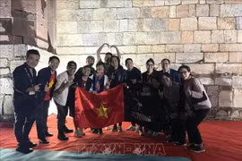 越南乐音爱好者与The wall乐队成员合影。图自越通社