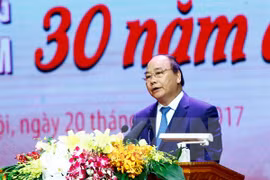 越南政府总理阮春福在“光荣越南-30年革新的烙印”活动上致辞。
