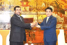 河内市人民委员会主席阮德钟（右）与阿曼驻越大使苏丹·萨夫·马哈鲁奇