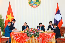 阮春福与老挝总理通伦出席两国系列合作文件的签署仪式。(图片来源：越通社）