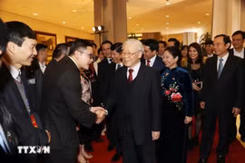 阮富仲总书记与归国参加“家乡之春”活动的旅外侨胞握手。越通社记者 智勇 摄