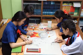 阮攸老越双语学校学生正在画胡伯伯肖像。图自越通社