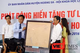 黄沙县人民委员会代表接收由人民捐赠的证明越南对黄沙群岛拥有主权的古地图。