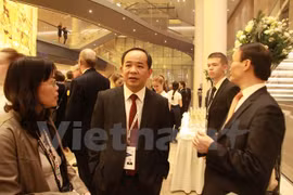 越南文化体育与旅游部副部长黎庆海与其他与会代表交流。