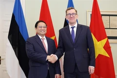 政府总理范明政与爱沙尼亚总理克里斯汀·米哈尔。图自越通社
