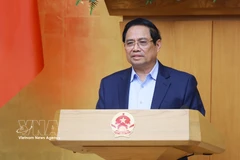 政府总理范明政在会上发表讲话。图自越通社