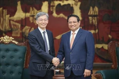越南政府总理范明政会见国际货币基金组织副总裁冈村健司。图自越通社
