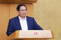 政府总理范明政在会议上发表讲话。图自越通社