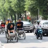 游客乘坐人力三轮车参观胡志明市中心。图自越通社