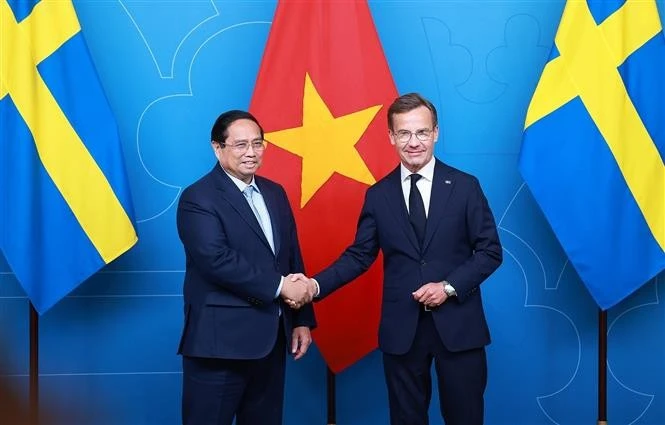越南政府总理范明政与瑞典首相乌尔夫·克里斯特松。图自越通社