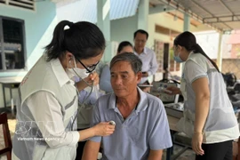 居民区连续健康服务医疗队为民众进行检查。图自越通社