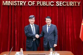 越共中央政治局、公安部长梁三光（右）大将与日本公共卫生安全协会副会长常田照男。图自越通社