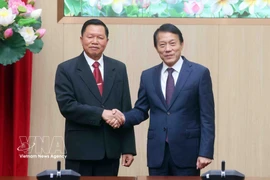 越共中央政治局委员、公安部部长梁三光大将（右）与老挝人民革命党中央书记处书记、公安部部长万通·贡马尼上将（左）。图自越通社