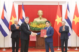 苏林总书记与米格尔·迪亚斯—卡内尔·贝穆德斯主席共同见证《越南—古巴经济和科技合作政府间委员会第42次会议纪要》的交换。图自越通社