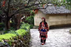 穿着传统服饰的倮倮族少女。图自越通社